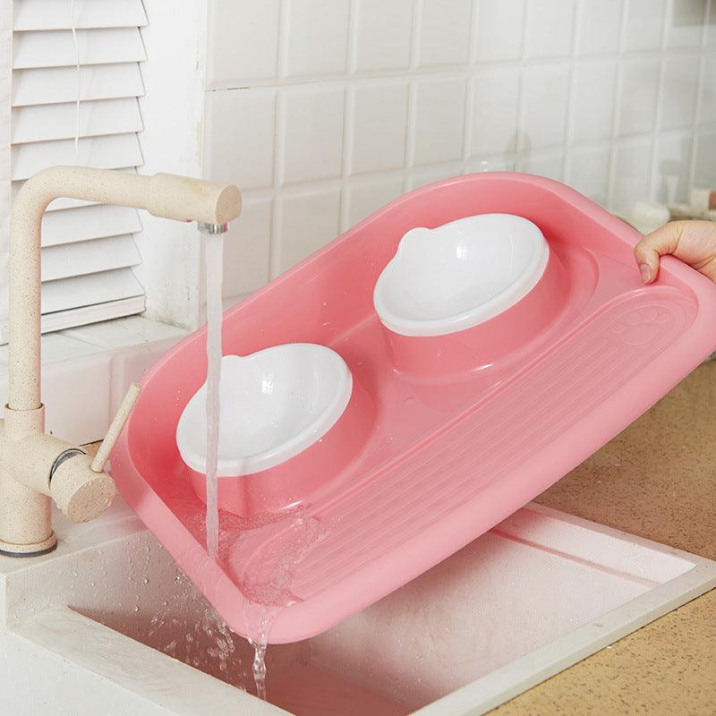 Dual-purpose pet feeding station in pink with two removable bowls for easy cleaning and pet feeding
