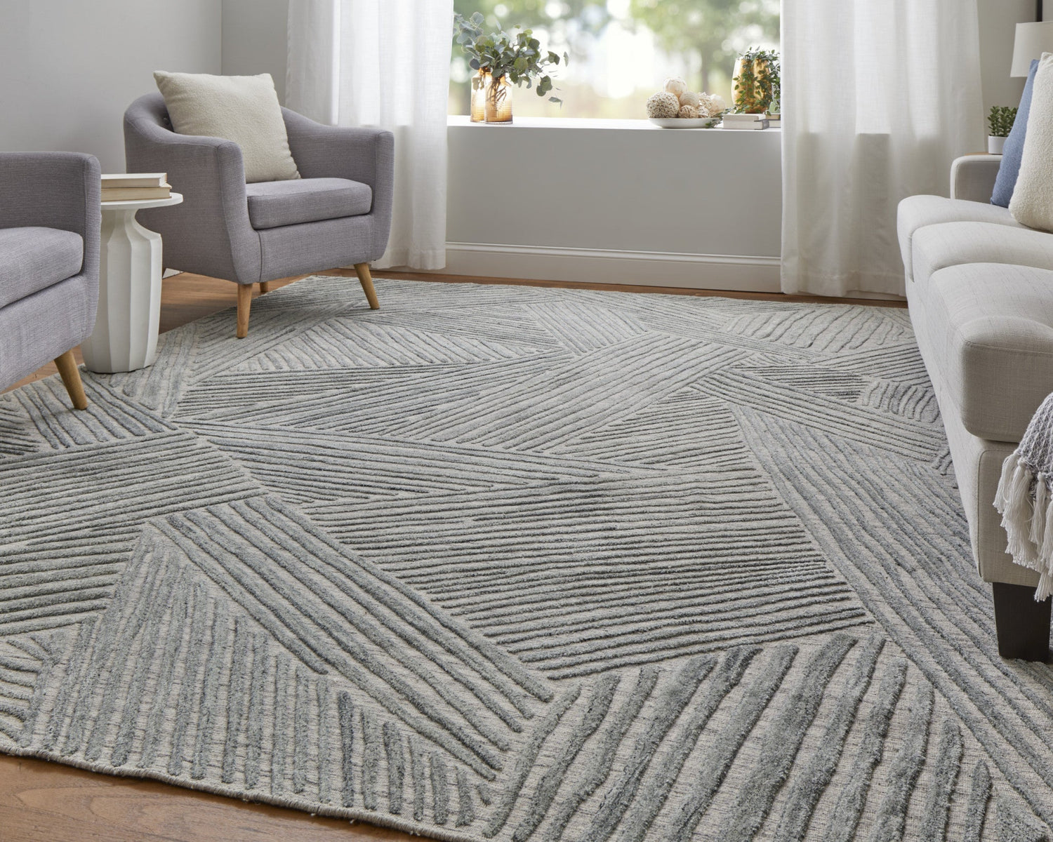 Stylish handmade living room rugs with a modern geometric design in a bright interior setting