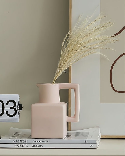 Stylish ceramic vase with dried flowers, complementing eco-friendly cooking utensils in a modern kitchen decor