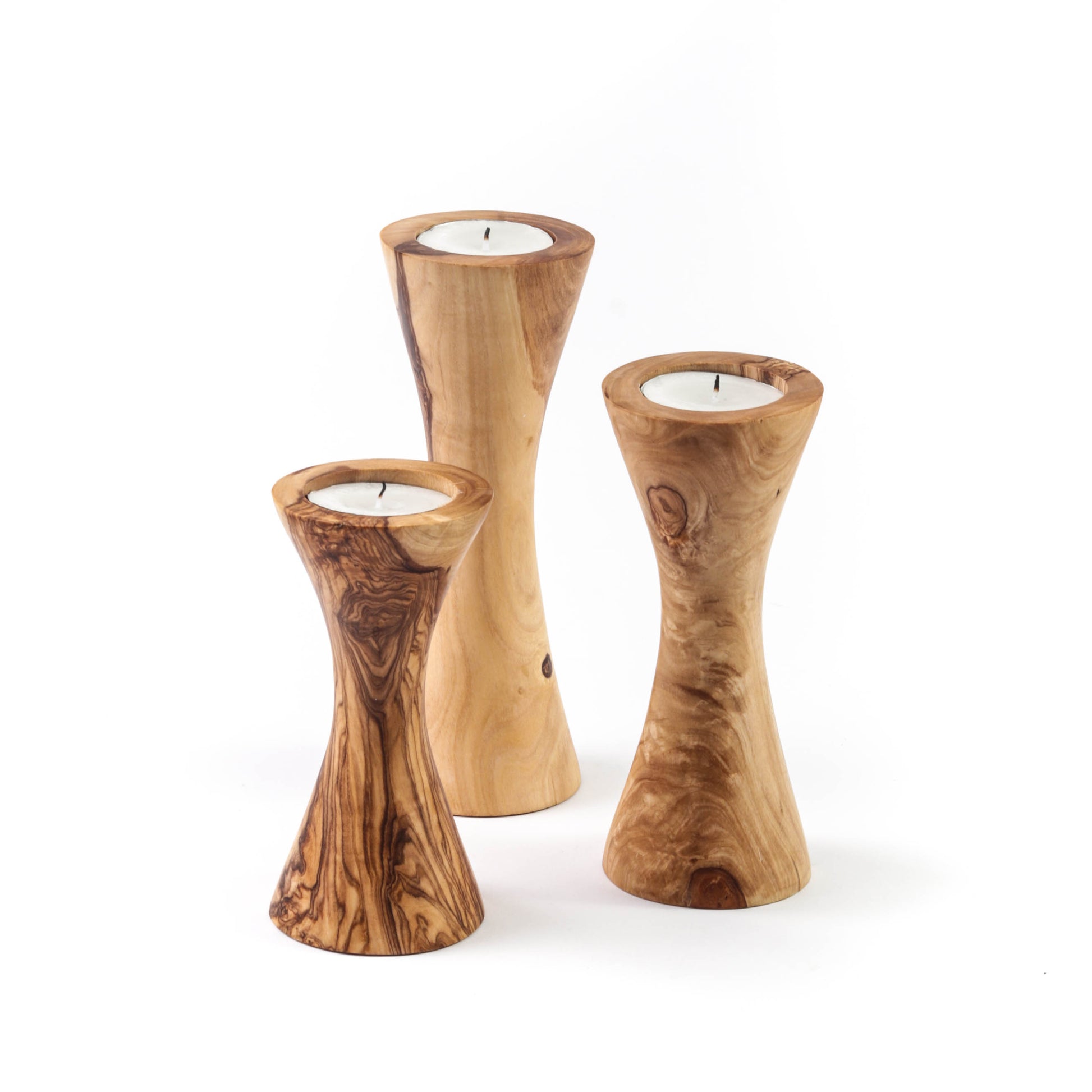 Set of three handcrafted olive wood candle holders featuring unique designs and a natural finish